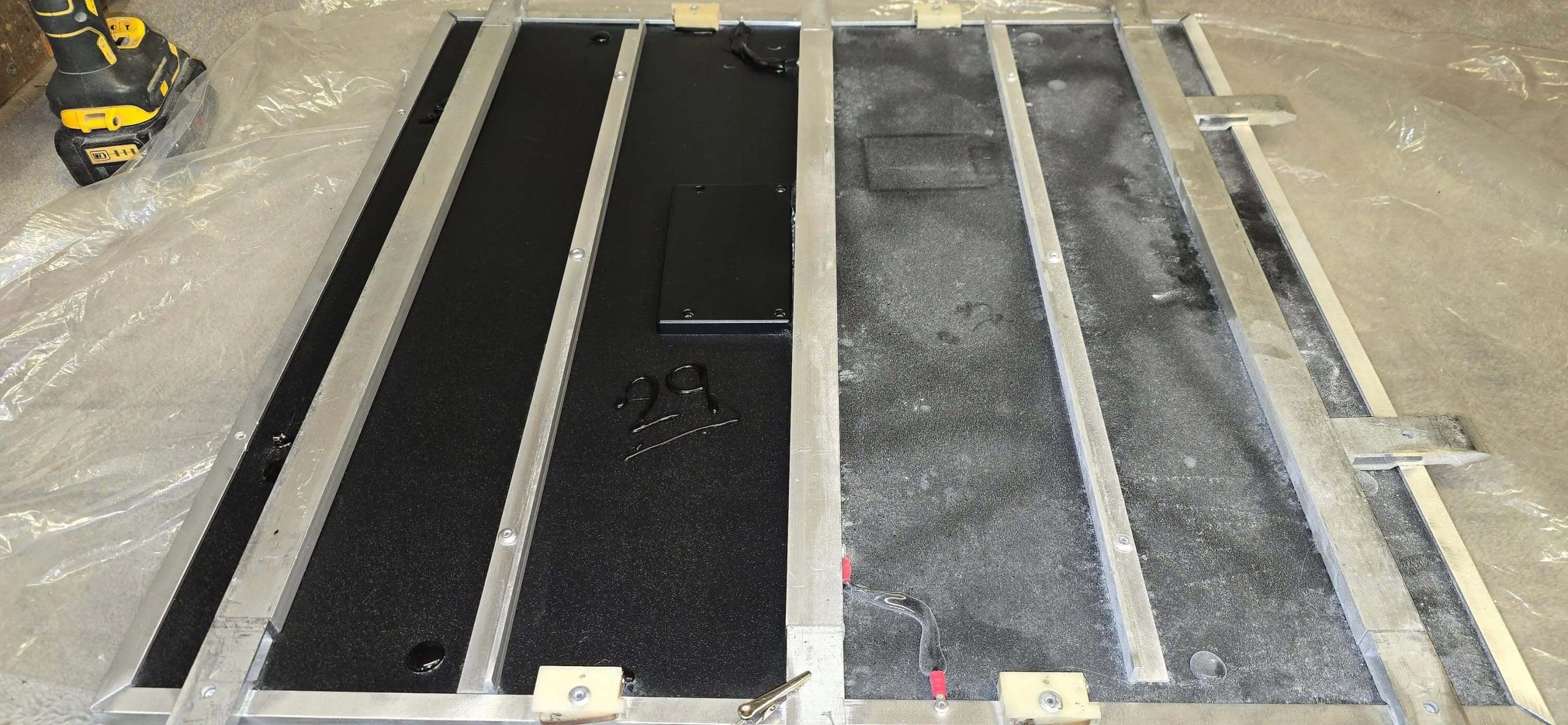Back of dance floor panel showing cleaned and uncleaned sections